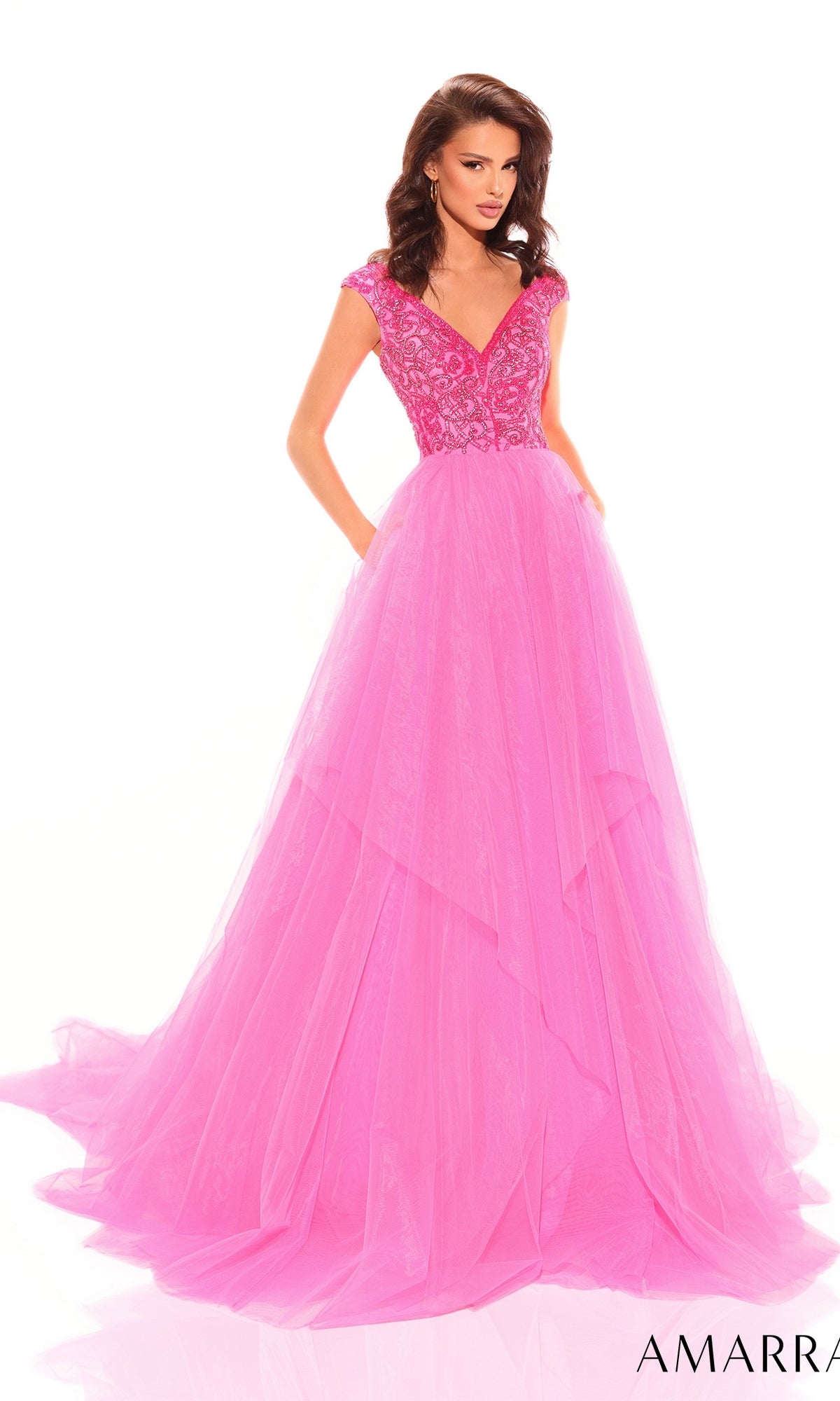 A woman wearing the Beaded-Bodice Long A-Line Prom Dress: Amarra 94038, a bright pink, floor-length gown with a fitted embellished bodice and cap sleeves, stands against a white background.